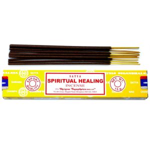Røgelsespinde og en gul æske med skriften "Spiritual Healing" fra mærket Satya.